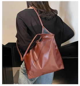 Detailed view of caramel tote bag with soft leather texture and slim shoulder straps