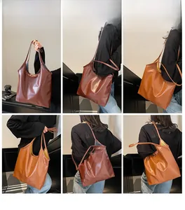 Detail view of large faux leather tote bags in dark coffee and tan with oil-wax finish