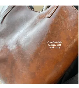 Macro detail showing soft vintage brown faux leather texture and material flexibility