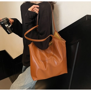 Close-up of caramel brown tote bag showing soft premium texture and minimalist design