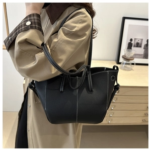 Detailed view of black lychee grain tote bag with white contrast stitching and tie details
