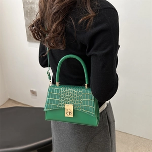 Green faux leather handbag with crocodile texture flap and gold turn-lock closure