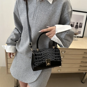 Classic black and white faux crocodile leather handbag with elegant gold metal twist lock