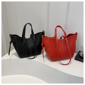 Detail of minimalist tote bags with white contrast stitching and soft pebbled leather