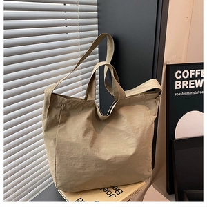 Detail of khaki large capacity nylon tote bag with shoulder straps for commuting