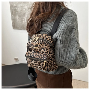 Leopard print mini backpack with golden zippers shown on a model for daily travel look