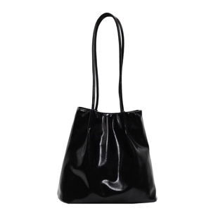 Minimalist black patent leather tote bag with glossy finish and long shoulder straps