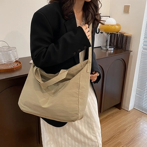 Minimalist large capacity khaki canvas tote bag with wide strap for daily commute use