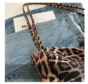 Close-up of leopard print tote bag showing double stitching and pebbled leather texture
