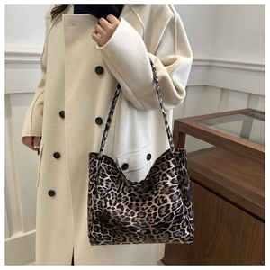 Leopard print tote bag paired with an elegant cream wool coat in a stylish indoor setting