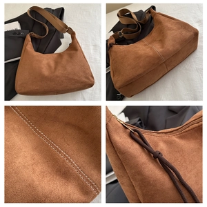 Detail showing white stitching on brown suede crossbody bag with thick woven rope zipper