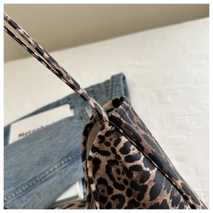Detail of leopard print shoulder strap featuring high-quality stitching on a tote bag