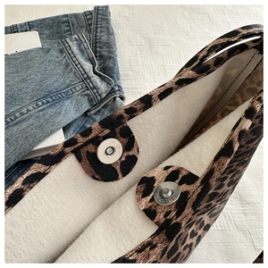 Detail of leopard print tote bag interior featuring magnetic snap button closures