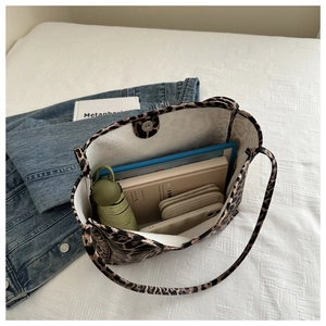Interior detail of large leopard print tote bag showing storage for tablet and wallet