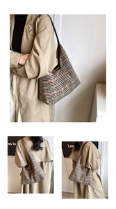 Detail of the houndstooth weave texture and leather strap on this large tote bag
