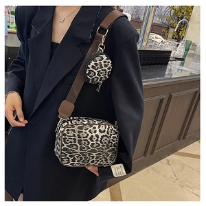 Detail of leopard print crossbody bag with matching round coin purse and brown strap