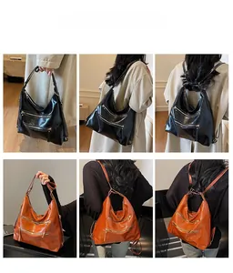 Vue détaillée du sac à dos en cuir avec fermetures éclair doubles et bandoulières