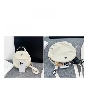 Detailed interior storage view of the nylon crossbody bag showing smartphone and cosmetics