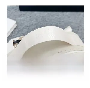 Detail of reinforced fabric handles and dual zippers on lightweight nylon round bag