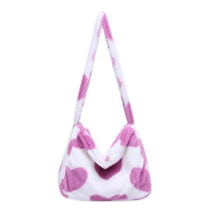 Pink and white heart pattern plush tote bag with furry shoulder strap on white background