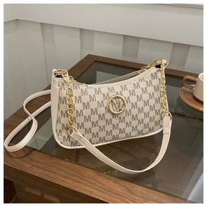 Detail of beige crescent underarm bag with M monogram print and gold metal logo
