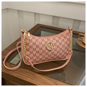 Detail of orange-pink underarm bag with M-pattern texture and gold metal logo