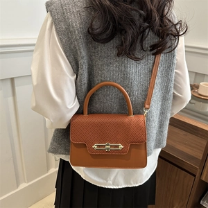 Caramel brown square crossbody bag with snake texture flap and golden buckle detail