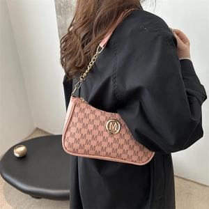 Pink monogram armpit bag with gold M logo and leather-chain strap for women