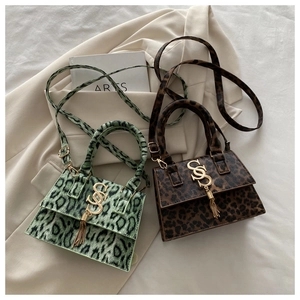 Detail of leopard print mini bags with gold logo, tassels and metal chain straps