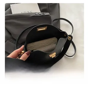 Interior view of black pebbled leather bucket bag showing capacity for daily essentials