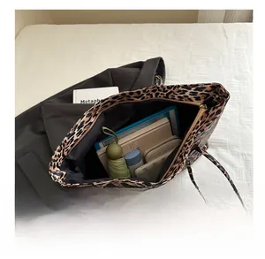 Macro view of leopard print tote bag interior showing large storage capacity for tablets