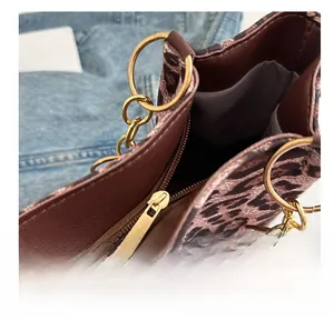 Macro detail of leopard print tote bag with smooth metal zipper and gold ring hardware