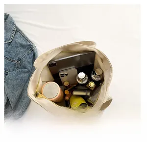 Top view of spacious nylon tote bag interior showing laptop and daily essentials