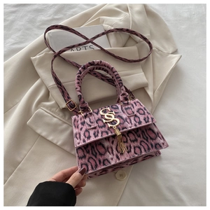 Detailed view of pink leopard print mini bag with fringe tassel and gold hardware accents