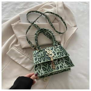 Detail of green leopard print faux fur handbag with golden S-buckle and elegant tassel