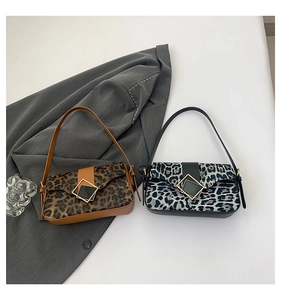 Detail of leopard print underarm bags in brown and grey with golden square buckles
