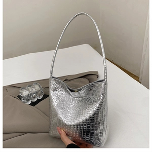 Detailed view of silver crocodile pattern texture on modern minimalist shoulder bag