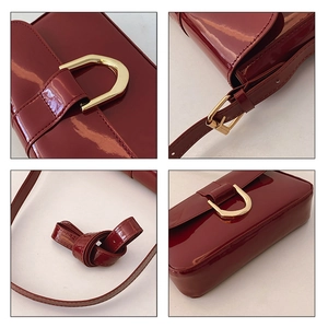 Detailed views of wine red patent leather shoulder bag with golden buckle and strap