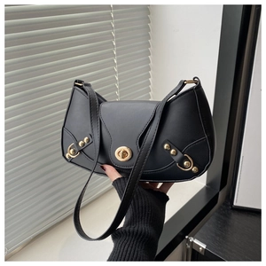 Detail of black crescent shoulder bag with gold twist lock and metallic hardware accents