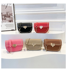 Row of five colorful crossbody saddle bags with gold rivets and chain straps on display