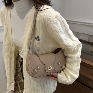 Beige faux leather crescent underarm bag with gold metal hardware and rotating lock