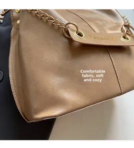 Detail of khaki PU leather bucket bag with litchi texture and golden chain strap
