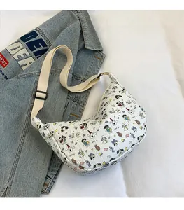 Detail of crescent crossbody bag with cartoon print on textured cream fabric