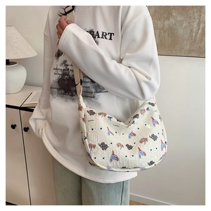 Detail of off-white quilted crossbody bag featuring a cute cartoon elephant print