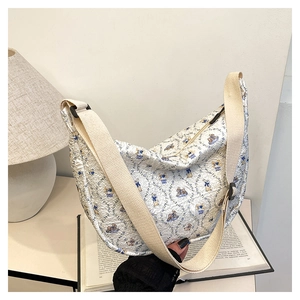 Detail of quilted crossbody bag featuring cute rabbit prints and adjustable strap