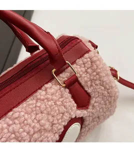 Close-up of premium gold hardware and plush shearling texture on the barrel bag