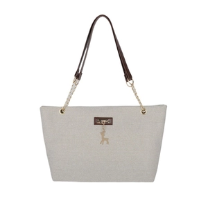 Light gray woven tote bag with brown leather straps and gold deer charm detail