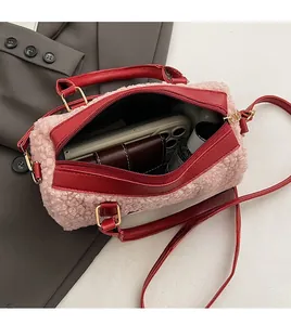 Spacious interior of pink fleece cylinder bag showing capacity for phone and wallet