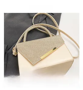 Detail showing the cream leather texture and gold glitter finish on this stylish handbag