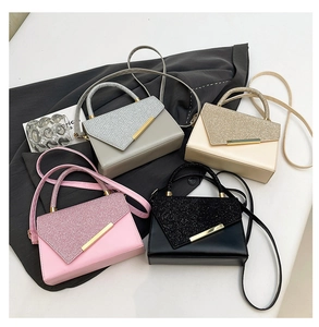 Detail showing four colors of textured envelope shoulder bags with gold trim accents